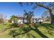 White single story home with red roof accents and mature landscaping at 1973 Hawaii Ne Ave, St Petersburg, FL 33703