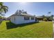 White single story home with red roofline, and green lawn at 1973 Hawaii Ne Ave, St Petersburg, FL 33703