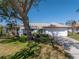 White single-story house with a two-car garage and mature landscaping at 1973 Hawaii Ne Ave, St Petersburg, FL 33703