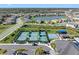 Aerial view of a community featuring tennis courts, a playground, a pond, manicured lawns, and modern homes at 32707 Tamarind Grove Ln, Wesley Chapel, FL 33543