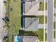 Bird's eye view showing the layout of a house with a pool, lawn, and surrounding landscape at 32707 Tamarind Grove Ln, Wesley Chapel, FL 33543