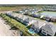 Aerial view of homes with backyard pools bordering community green spaces in a growing residential area at 32707 Tamarind Grove Ln, Wesley Chapel, FL 33543