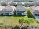 Aerial view of a suburban neighborhood with manicured lawns and the rear of several houses at 32707 Tamarind Grove Ln, Wesley Chapel, FL 33543