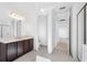 Bright bathroom featuring a large vanity, toilet, and an open doorway to another bedroom at 32707 Tamarind Grove Ln, Wesley Chapel, FL 33543