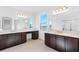 Bathroom featuring double vanities, tile flooring, and a separate shower area at 32707 Tamarind Grove Ln, Wesley Chapel, FL 33543