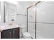 Updated Bathroom with a dark vanity, modern shower and lots of light at 32707 Tamarind Grove Ln, Wesley Chapel, FL 33543