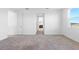 Bright bedroom boasts neutral carpeting, crisp white walls, and an ensuite bathroom, perfect for relaxation at 32707 Tamarind Grove Ln, Wesley Chapel, FL 33543