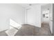 Empty bedroom with neutral carpet and a double door closet, bathed in sunlight at 32707 Tamarind Grove Ln, Wesley Chapel, FL 33543