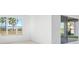 A bright bedroom with a window and sliding glass door that leads to a backyard at 32707 Tamarind Grove Ln, Wesley Chapel, FL 33543