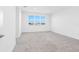 Large bedroom with natural light and neutral carpet, creating a comfortable and airy ambiance at 32707 Tamarind Grove Ln, Wesley Chapel, FL 33543