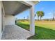 Covered patio featuring a paver floor and providing ample space for outdoor relaxation with beautiful view at 32707 Tamarind Grove Ln, Wesley Chapel, FL 33543