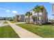Lovely home on a manicured lawn, showcasing paver driveway, a lush lawn, and sidewalk at 32707 Tamarind Grove Ln, Wesley Chapel, FL 33543