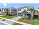 Beautiful two-story home with a well-manicured lawn and a gray driveway at 32707 Tamarind Grove Ln, Wesley Chapel, FL 33543