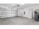 Spacious garage with automatic door, concrete floors and utility connections at 32707 Tamarind Grove Ln, Wesley Chapel, FL 33543