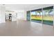 Bright living space flows into a modern kitchen, with a sliding glass door opening to the yard at 32707 Tamarind Grove Ln, Wesley Chapel, FL 33543
