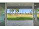 Open patio doors offering expansive views of the lush green lawn and landscape at 32707 Tamarind Grove Ln, Wesley Chapel, FL 33543