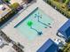 An aerial view of the splash pad, featuring colorful water features within a gated and covered lounge area at 32707 Tamarind Grove Ln, Wesley Chapel, FL 33543