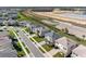 Aerial view of a residential street with well-maintained lawns, sidewalks, and stylish homes in a planned community at 32707 Tamarind Grove Ln, Wesley Chapel, FL 33543
