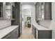 Elegant bar with grey cabinetry, a wine fridge, and marble countertops and backsplash at 5024 W Dickens Ave, Tampa, FL 33629