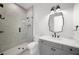 Elegant bathroom features a glass-enclosed shower, sleek vanity, and stylish mirror at 5024 W Dickens Ave, Tampa, FL 33629