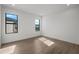 Sunlit bedroom with hardwood floors and white walls, complemented by large windows at 5024 W Dickens Ave, Tampa, FL 33629
