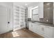 Bright butler's pantry with custom shelving, quartz countertops and modern stainless steel appliances at 5024 W Dickens Ave, Tampa, FL 33629