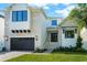 Charming two-story house featuring a brick facade, black framed windows, and well-maintained landscaping at 5024 W Dickens Ave, Tampa, FL 33629