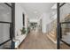 Grand foyer with light wood floors, white walls, a staircase, and a view into the living spaces at 5024 W Dickens Ave, Tampa, FL 33629