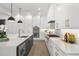 Gourmet kitchen featuring stainless steel appliances, custom white cabinetry, and a large island with a sink at 5024 W Dickens Ave, Tampa, FL 33629