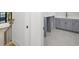 Upstairs landing with grey cabinets, sink, and views to the stairwell and backyard at 5024 W Dickens Ave, Tampa, FL 33629
