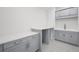 Bright laundry room with grey cabinets, countertops, and sink at 5024 W Dickens Ave, Tampa, FL 33629