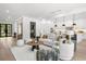 Spacious living area showcasing a modern design with an open layout into kitchen and large windows at 5024 W Dickens Ave, Tampa, FL 33629