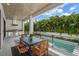 Inviting covered outdoor kitchen with built-in grill overlooking pool and lush backyard at 5024 W Dickens Ave, Tampa, FL 33629