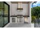 Outdoor kitchen boasts stainless steel appliances and granite countertops, perfect for entertaining at 5024 W Dickens Ave, Tampa, FL 33629