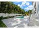 Backyard features a sparkling pool with spa, complemented by travertine patio, and lush landscaping at 5024 W Dickens Ave, Tampa, FL 33629
