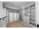 Custom walk-in closet with shelves, drawers, hanging racks, and wood floors at 5024 W Dickens Ave, Tampa, FL 33629