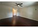 Spacious bedroom with dark wood laminate flooring and a ceiling fan at 8413 Silverbell Loop, Brooksville, FL 34613