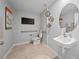 Modern accessible bathroom with a floating sink, toilet, and grab bars at 105 Lilyan Ct, Rotonda West, FL 33947