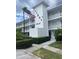 Two-story condo building with manicured landscaping and assigned parking at 11201 80Th Ave # 201, Seminole, FL 33772
