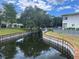 Peaceful waterfront view with lush landscaping at 11201 80Th Ave # 201, Seminole, FL 33772