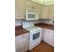 Kitchen boasting white appliances, wood cabinets, and brown countertops at 11201 80Th Ave # 201, Seminole, FL 33772