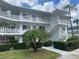 Condo building showcasing multiple units with balconies and lush greenery at 11201 80Th Ave # 201, Seminole, FL 33772