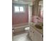 Bathroom with pink tile, a tub, and a vanity with storage at 11201 80Th Ave # 201, Seminole, FL 33772