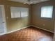 Well-lit bedroom with parquet flooring and window blinds at 11201 80Th Ave # 201, Seminole, FL 33772