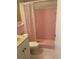 Pink tiled bathroom with shower, toilet and vanity at 11201 80Th Ave # 201, Seminole, FL 33772