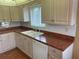 Galley kitchen with wood cabinets, updated countertops and appliances at 11201 80Th Ave # 201, Seminole, FL 33772