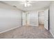 Spacious bedroom with neutral carpet, fan, and closets at 11200 102Nd Ave # 33, Seminole, FL 33778