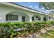 Charming white condo with arched entryway and lush green hedges at 11200 102Nd Ave # 33, Seminole, FL 33778