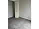 Carpeted bedroom with double-door closet and window at 2688 Pine Ridge N Way # D1, Palm Harbor, FL 34684
