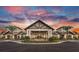 Elegant clubhouse entrance with stone accents and landscaping at 4943 Ribbon Rock Cv, Lakewood Ranch, FL 34211